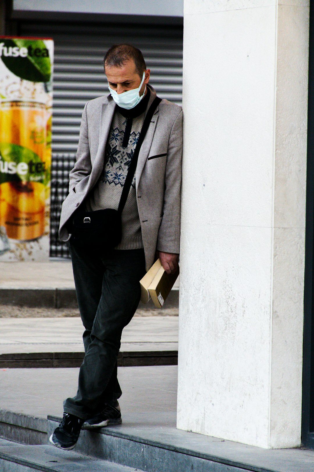 Older European male journalist holding a reporter notebook