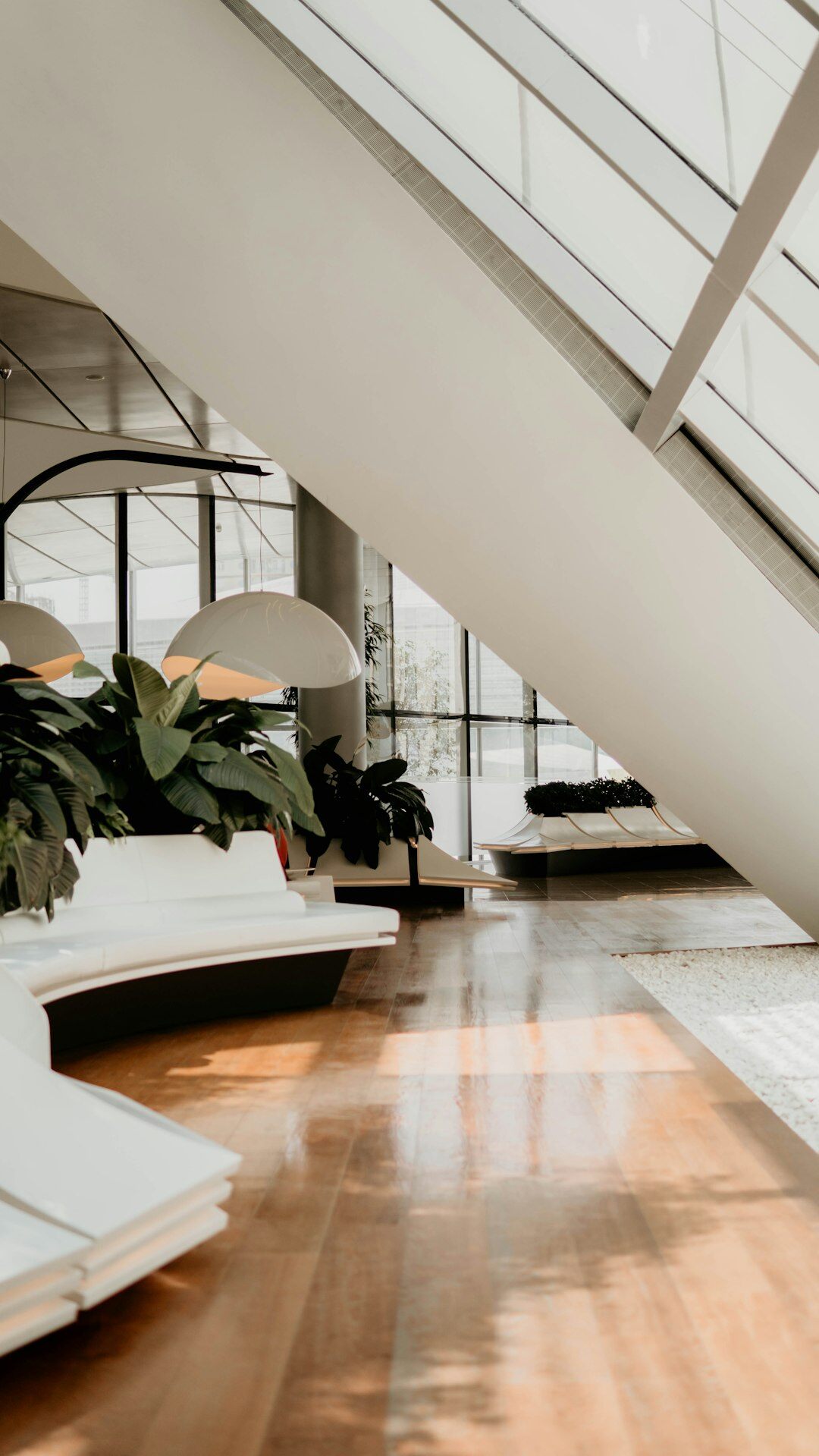 Bright modern office reception area with plants and seating